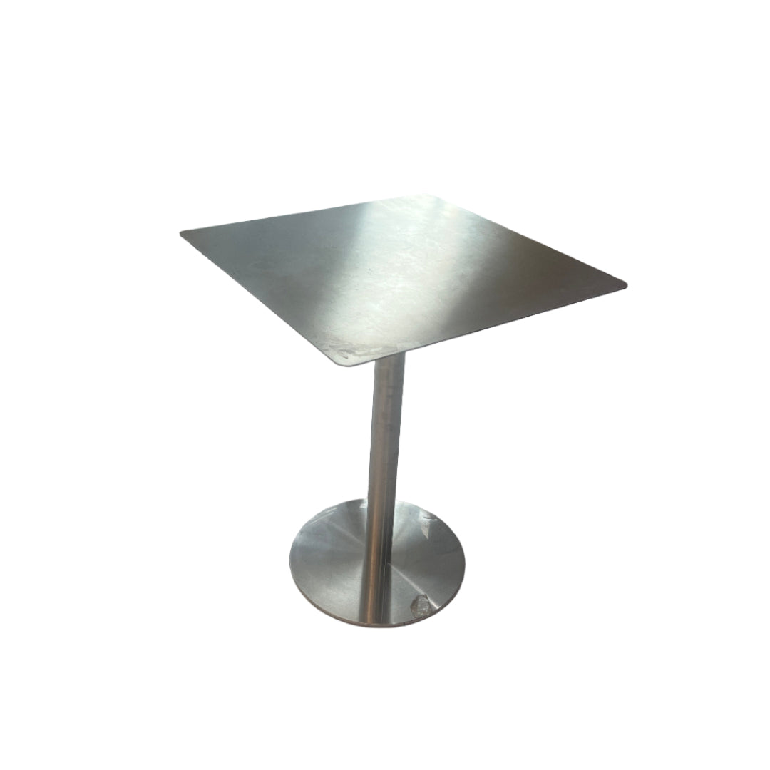 Metallic object on a tiled floor with a glass door in the background