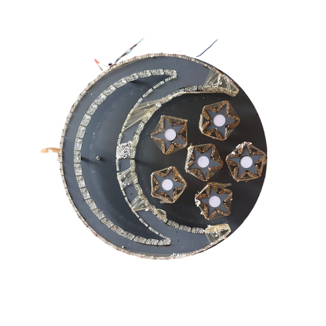 Decorative plate with star designs on a wooden stand against a corrugated metal background