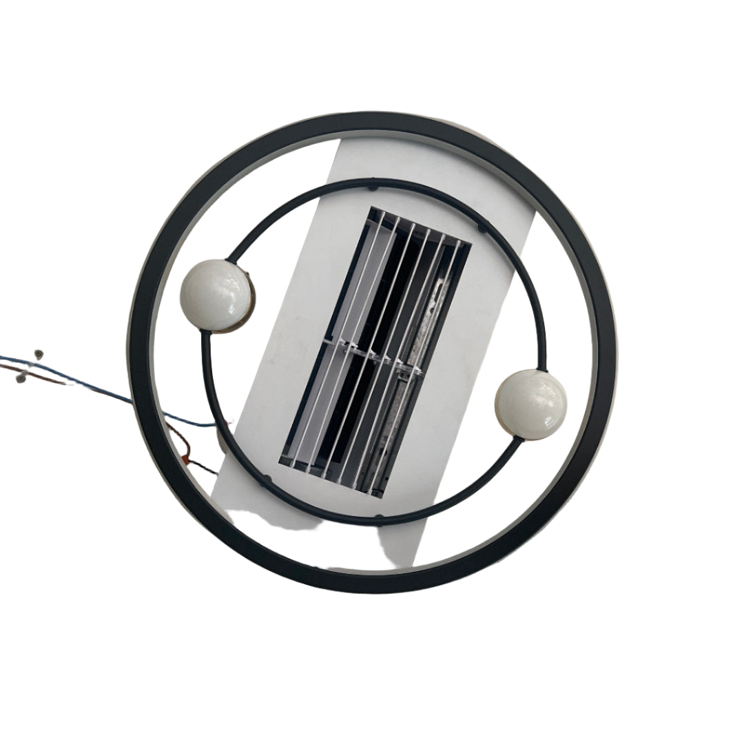 Round white light fixture with black frame on a wooden floor