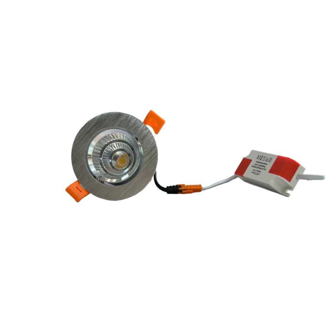 Light fixture with orange accents on a white surface, with a blurred background