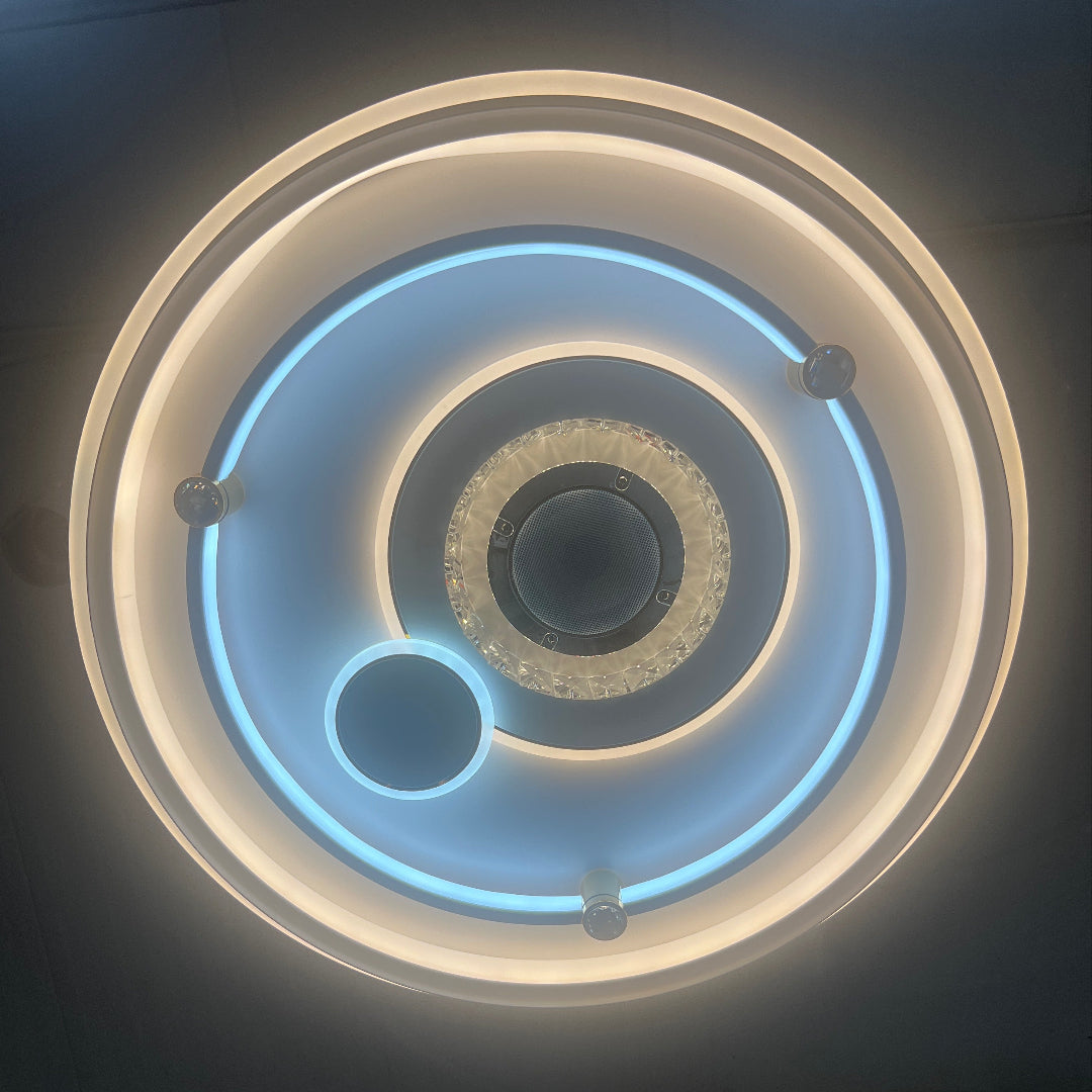 Circular light fixture with concentric rings on a ceiling