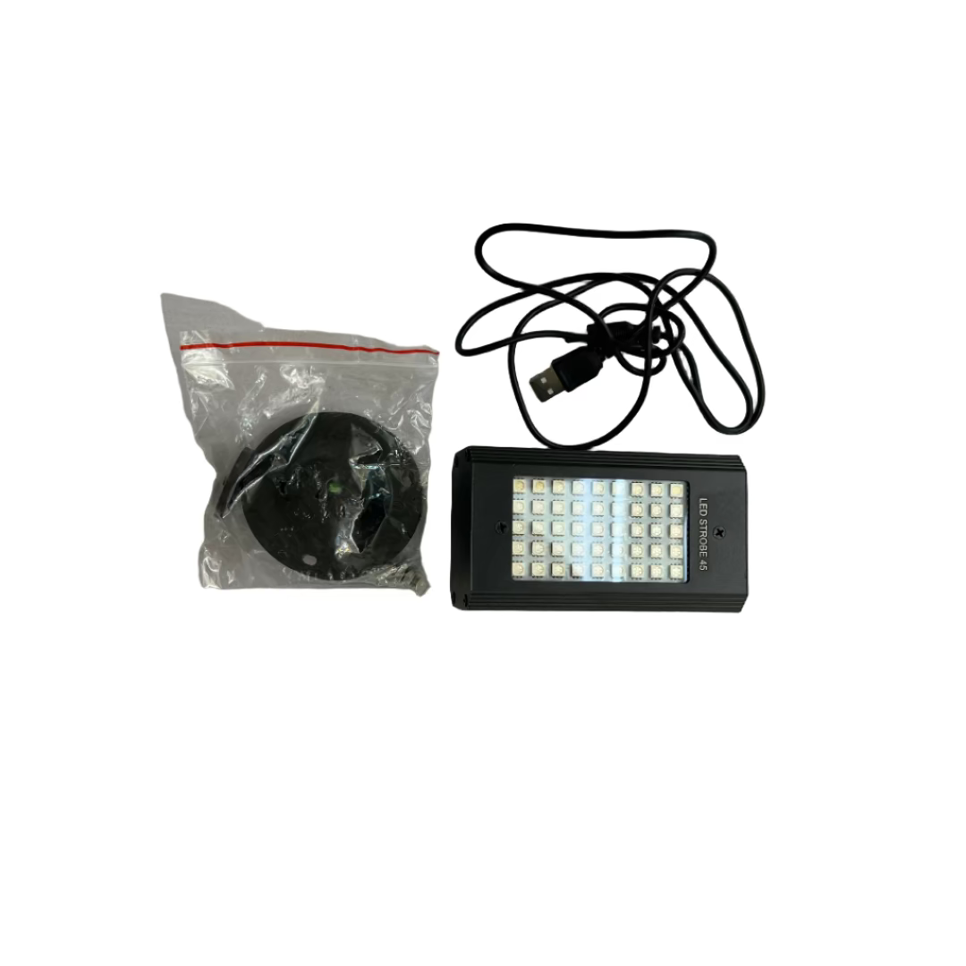 Black LED light and USB cable on a white surface