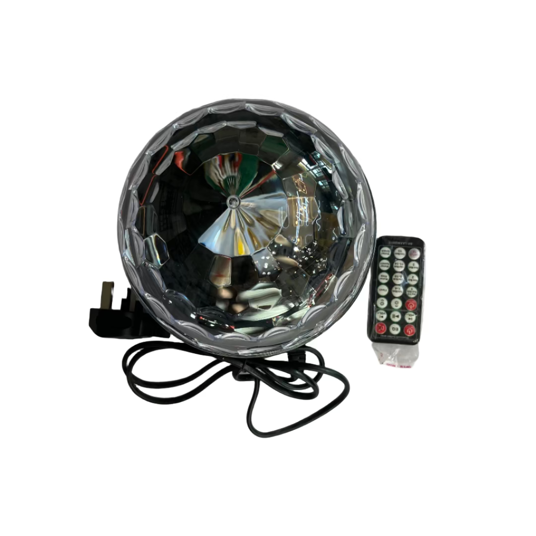 Round electronic device with wires and a remote control on a white surface
