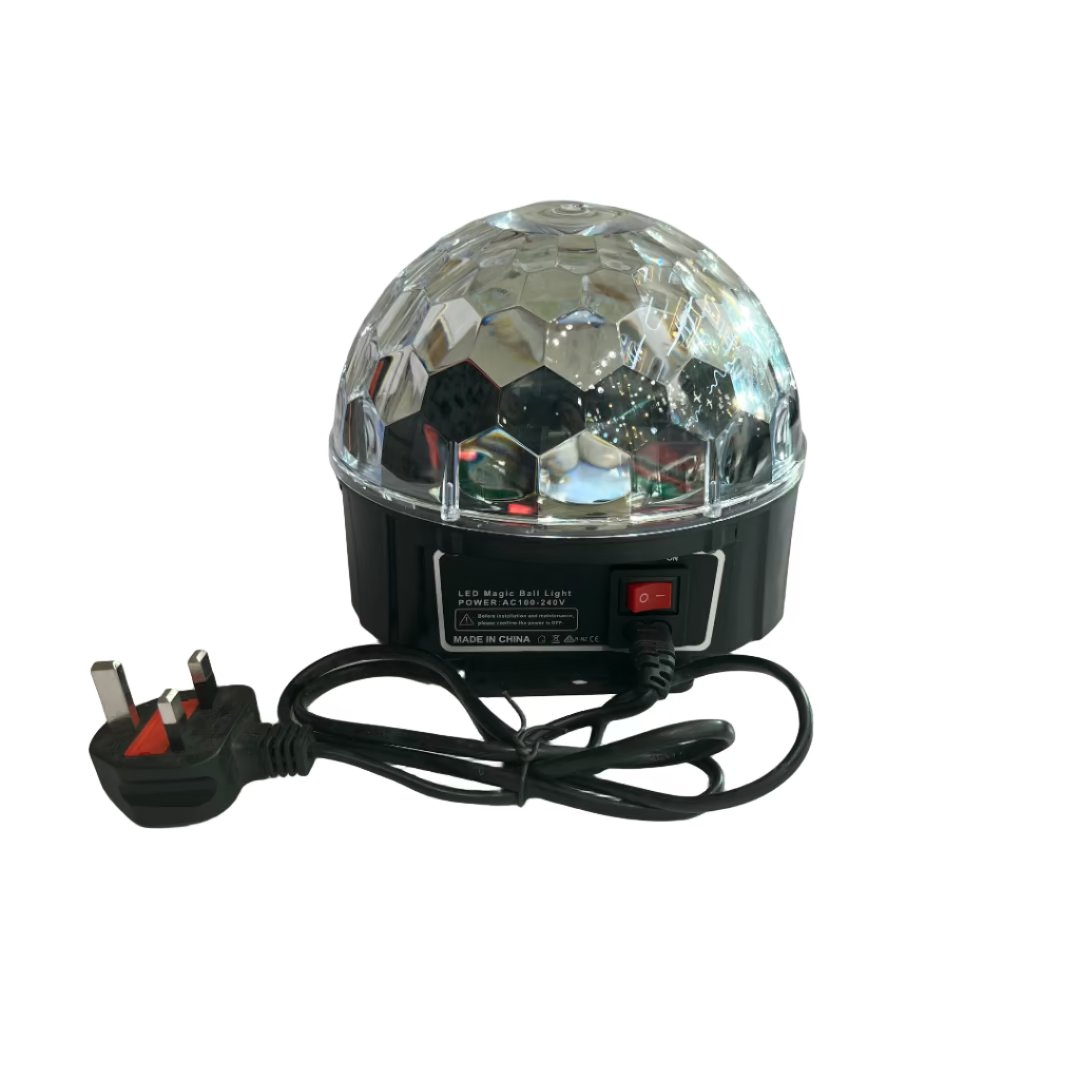 Crystal ball light on a white surface with a fan and wall decorations in the background