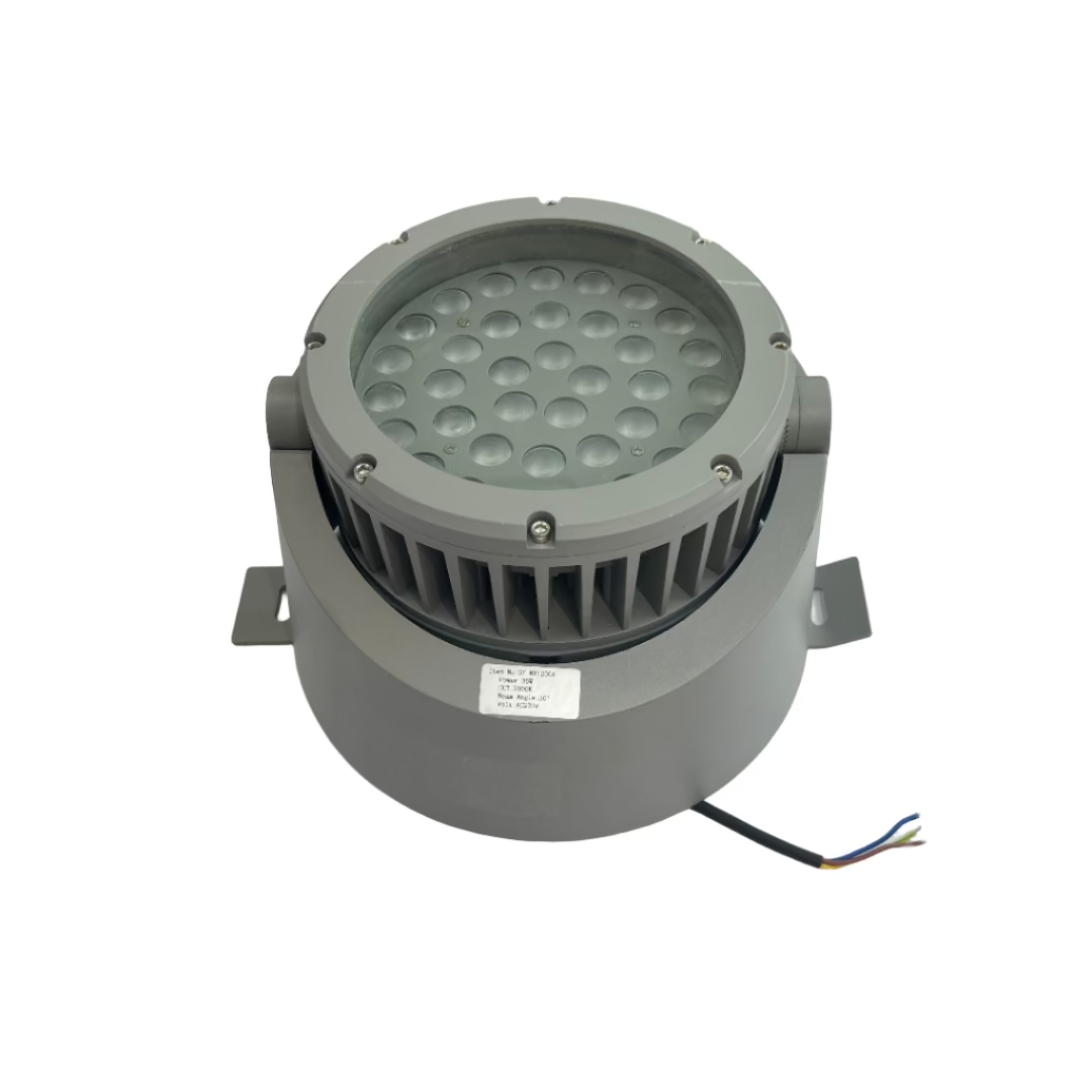 Gray cylindrical light fixture on a white surface with a blurred background