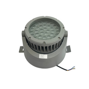 Gray cylindrical light fixture on a white surface with a blurred background