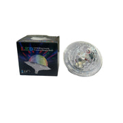 Clear glass object on a white surface with a map and books in the background