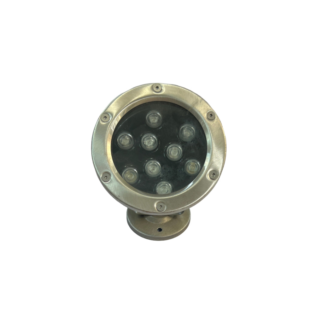 Round metal light fixture on a white surface 