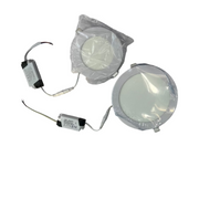 Two round light fixtures and a power supply on a white surface